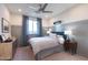 Stylized bedroom featuring a ceiling fan, large window, and modern decor at 4961 W Walatowa St, Laveen, AZ 85339