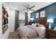 Bedroom featuring a leather headboard, mountain view, and a ceiling fan at 4961 W Walatowa St, Laveen, AZ 85339