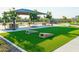 Community area with turf horseshoe pits, picnic tables, shade structure, and climbing structure at 4961 W Walatowa St, Laveen, AZ 85339