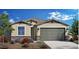 Charming single-story home with stone accents, desert landscaping, and a two-car garage at 4961 W Walatowa St, Laveen, AZ 85339