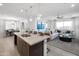 Open concept living area with large island, stainless steel appliances, and a view to the living room at 4961 W Walatowa St, Laveen, AZ 85339