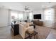 Spacious living room features neutral tones, a comfortable sectional sofa, and large windows that flood the room with natural light at 4961 W Walatowa St, Laveen, AZ 85339
