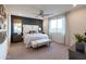 A serene main bedroom features a ceiling fan, and large window, providing a relaxing retreat at 4961 W Walatowa St, Laveen, AZ 85339