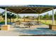 A picnic area with shaded structure featuring multiple picnic tables and park views at 4961 W Walatowa St, Laveen, AZ 85339