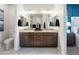 Modern bathroom with dual vanities, stylish mirrors, and elegant finishes at 5019 W Walatowa St, Laveen, AZ 85339