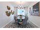 Elegant dining room featuring stylish decor, modern lighting, and a comfortable seating arrangement at 5019 W Walatowa St, Laveen, AZ 85339