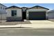 Charming single-Gathering home featuring stone accents, a two-car garage, and a well-maintained gravel yard at 5019 W Walatowa St, Laveen, AZ 85339