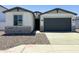 Charming single-Gathering home featuring stone accents, a two-car garage, and a well-maintained gravel yard at 5019 W Walatowa St, Laveen, AZ 85339