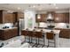 Modern kitchen with stainless steel appliances, a large island, and dark wood cabinets, perfect for entertaining at 5019 W Walatowa St, Laveen, AZ 85339