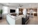 Well-lit living area featuring a comfortable sofa, modern décor, and an open layout to the kitchen at 5019 W Walatowa St, Laveen, AZ 85339