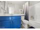 Bathroom with single sink vanity, blue cabinets, a toilet and tub with a shower at 5133 E Juana Ct, Cave Creek, AZ 85331