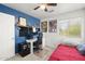 This bedroom features a ceiling fan, a desk, and a vibrant blue accent wall at 5133 E Juana Ct, Cave Creek, AZ 85331