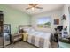 Cozy bedroom with a ceiling fan, window and unique artwork, creating a comfortable and inviting space at 5133 E Juana Ct, Cave Creek, AZ 85331