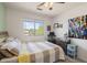 Comfortable bedroom featuring a large window, dresser and colorful art; a serene and well-lit living space at 5133 E Juana Ct, Cave Creek, AZ 85331