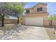 Charming front exterior highlighting the desert landscaping, two-car garage, and a light-colored facade at 5133 E Juana Ct, Cave Creek, AZ 85331