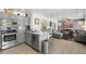 Modern kitchen with stainless steel appliances, gray cabinetry, a kitchen island, and tile flooring at 5133 E Juana Ct, Cave Creek, AZ 85331