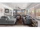 Spacious living room featuring comfortable gray sofas, a ceiling fan, and lots of natural light at 5133 E Juana Ct, Cave Creek, AZ 85331
