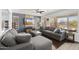 Open living room with hardwood floors, a gray sectional sofa, and a large window for natural light at 5133 E Juana Ct, Cave Creek, AZ 85331