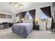 Spacious main bedroom features vaulted ceilings, ceiling fan, and large windows with lovely backyard views at 5133 E Juana Ct, Cave Creek, AZ 85331