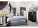 A view of the main bedroom and ensuite bath featuring a dark accent wall, tv, and large windows at 5133 E Juana Ct, Cave Creek, AZ 85331