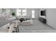 Bright open-concept living room features stylish white furniture, modern décor, and large windows for natural light at 5827 W Coplen Farms Rd, Laveen, AZ 85339