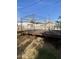 Backyard featuring deck with metal gazebo and mature landscaping, offering a private outdoor oasis at 8022 E 1St Ave, Mesa, AZ 85208