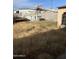 View of the backyard showing an above-ground pool and untended vegetation at 8022 E 1St Ave, Mesa, AZ 85208