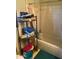 Modest bathroom features a tub-shower combination and adjacent shelving for storing linens and bath supplies at 8022 E 1St Ave, Mesa, AZ 85208