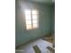 Small bedroom with blue painted walls and unfinished flooring at 8022 E 1St Ave, Mesa, AZ 85208