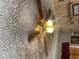 Low-angle view of a ceiling fan with light fixtures, set against a textured ceiling at 8022 E 1St Ave, Mesa, AZ 85208