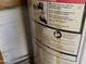 Important warnings and information are printed on the side of the water heater at 8022 E 1St Ave, Mesa, AZ 85208