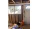 Under construction entrance with exposed framework, a window, and a partially boarded-up door at 8022 E 1St Ave, Mesa, AZ 85208