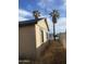 Classic one-story home with desert foliage and antenna on the roof at 8022 E 1St Ave, Mesa, AZ 85208
