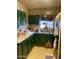 Kitchen with green cabinets, a sink, and linoleum floors at 8022 E 1St Ave, Mesa, AZ 85208