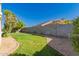 Backyard featuring green grass and decorative rock along the perimeter wall at 8104 S 73Rd Dr, Laveen, AZ 85339