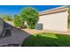 Paver-lined backyard with minimal landscaping, featuring an AC unit and perimeter wall at 8104 S 73Rd Dr, Laveen, AZ 85339