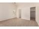 Unfurnished bedroom with neutral carpet, a window, and a closet at 8104 S 73Rd Dr, Laveen, AZ 85339