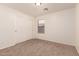 Neutral bedroom featuring sliding-door closet and a sunlit window at 8104 S 73Rd Dr, Laveen, AZ 85339