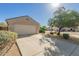 Well-maintained one-story home with a long driveway, two-car garage and tidy desert landscaping at 8104 S 73Rd Dr, Laveen, AZ 85339