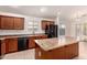 Bright kitchen with island, tile floor, and modern black appliances at 8104 S 73Rd Dr, Laveen, AZ 85339