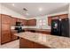Well-lit kitchen features an island, tile floors, and black appliances at 8104 S 73Rd Dr, Laveen, AZ 85339