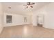 Large living room with neutral walls, tile floors, a ceiling fan and plentiful natural light at 8104 S 73Rd Dr, Laveen, AZ 85339