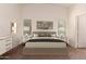 Staged bedroom featuring neutral color palette, plush carpet, and bright windows at 8104 S 73Rd Dr, Laveen, AZ 85339