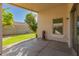 Covered patio area with textured walls and a view of the green yard at 8104 S 73Rd Dr, Laveen, AZ 85339