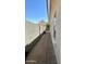 Paver side yard with block wall and view of back yard at 8104 S 73Rd Dr, Laveen, AZ 85339