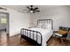 Cozy bedroom featuring modern decor, ceiling fan, and hardwood floors at 8143 E Whitton Ave, Scottsdale, AZ 85251