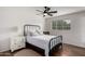 Bright bedroom featuring a black metal bed frame, ceiling fan, and window views at 8143 E Whitton Ave, Scottsdale, AZ 85251