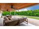 Inviting covered patio with wood ceiling, ceiling fans and comfortable seating area overlooking the lush backyard at 8143 E Whitton Ave, Scottsdale, AZ 85251