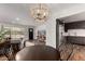 Open-concept living space featuring a modern light fixture, stainless steel appliances, and wood floors at 8143 E Whitton Ave, Scottsdale, AZ 85251