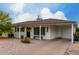 Charming single-story home featuring a covered porch, landscaped front yard with decorative rock, and flowering bushes at 8143 E Whitton Ave, Scottsdale, AZ 85251